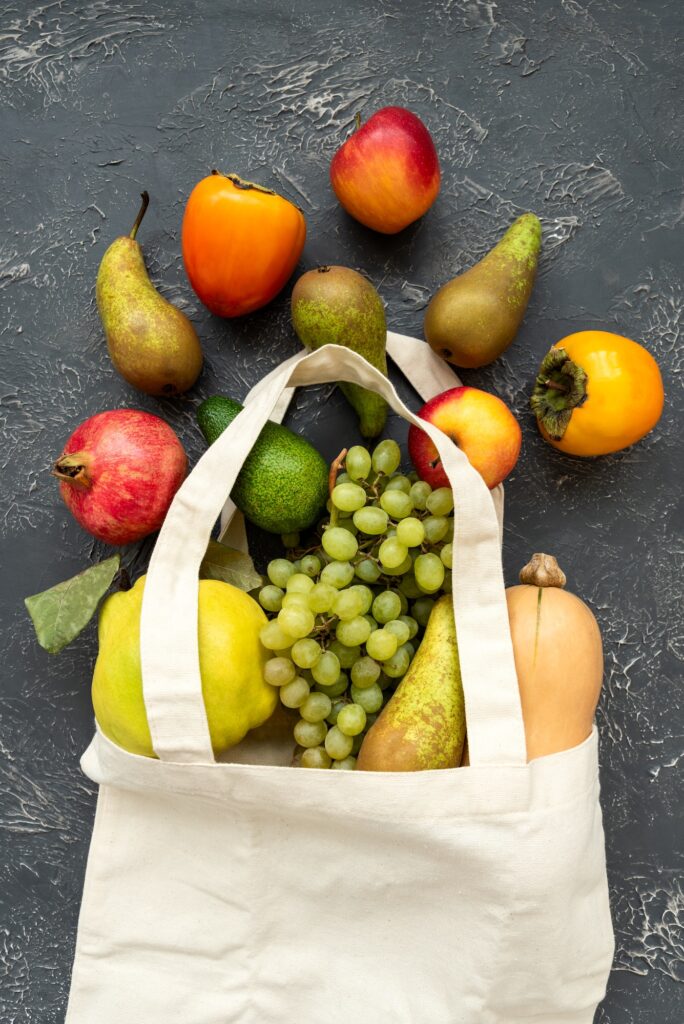 Bag of different health food on gray concrete background. Top view. Flat lay