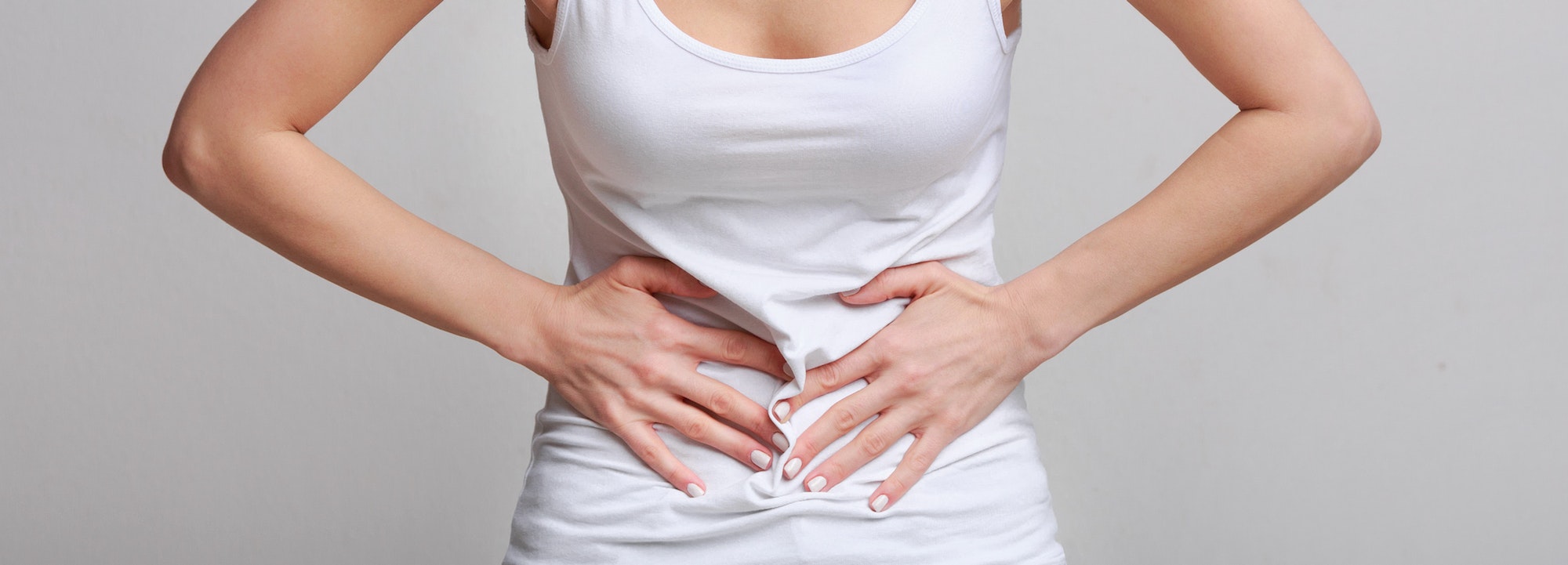 Woman with stomachache, having food poisoning, grey background