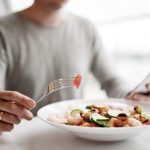 millennial man eats healthy food